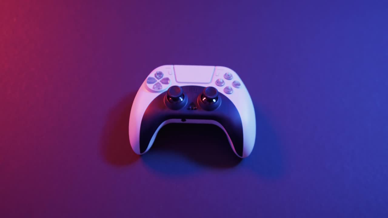 Video of close up of video game pad controller with copy space on neon background