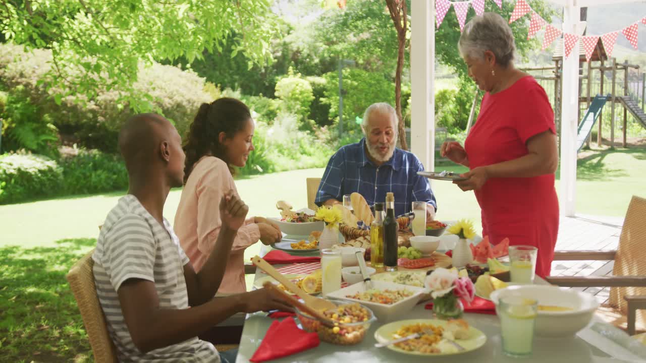 Multi-generation African American family spending time in garden together