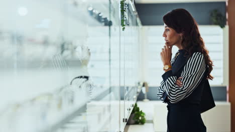 woman looking at jewelry display in a store