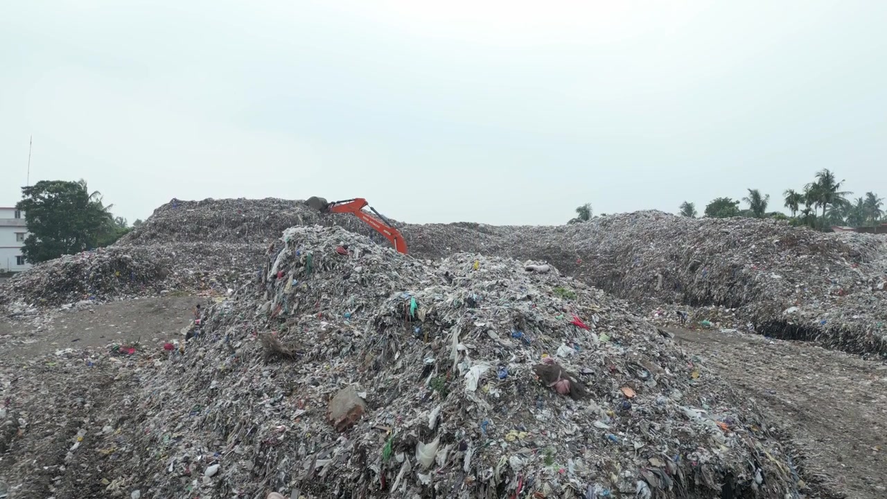 Drone reveal shot of huge garbage dump or landfill in india