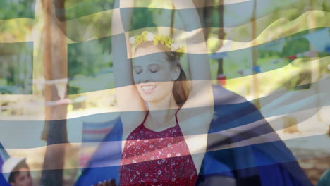 Dancing outdoors at festival, woman with Greek flag animation overlay