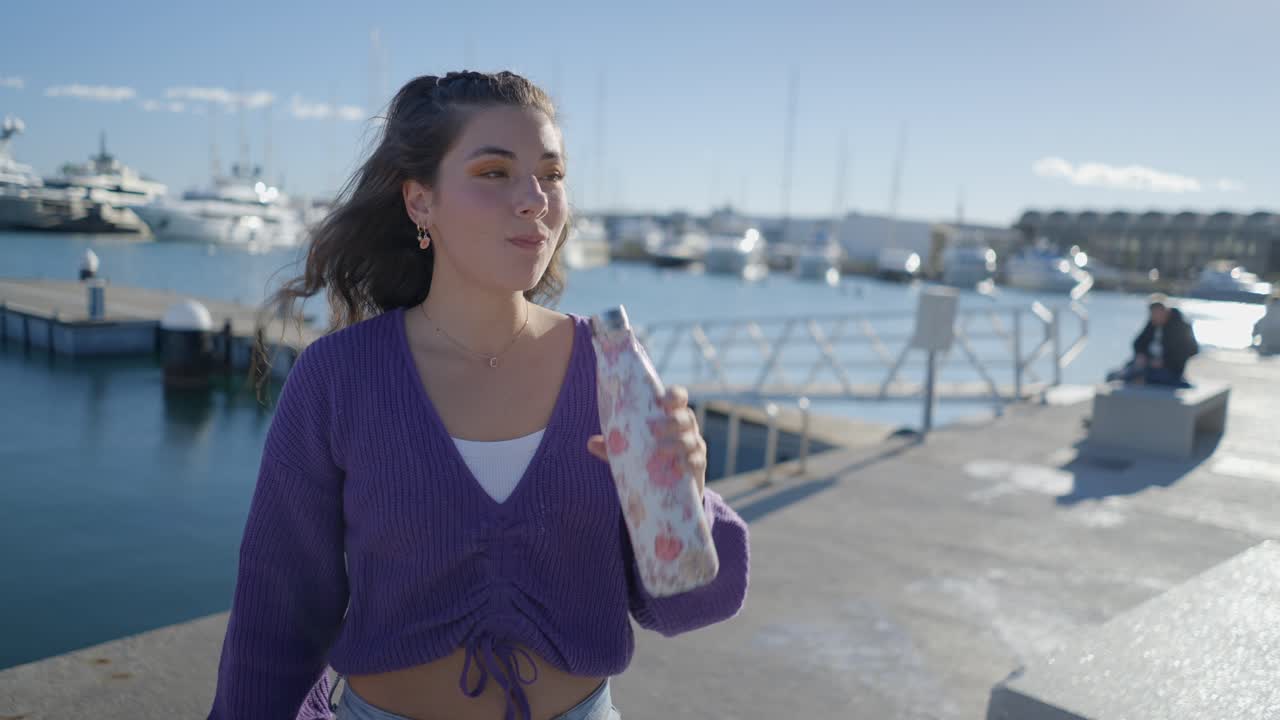 Woman Drinking Water Bottle at Marina