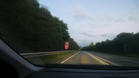 timelapse car pov on british road at sunset with car headlights and roadworks devon uk 4k