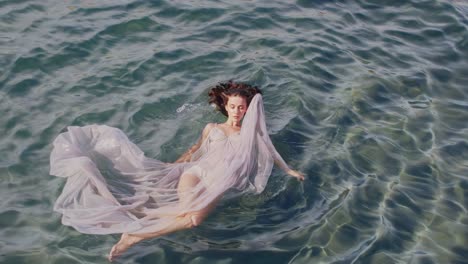 woman in a dress floating on the water