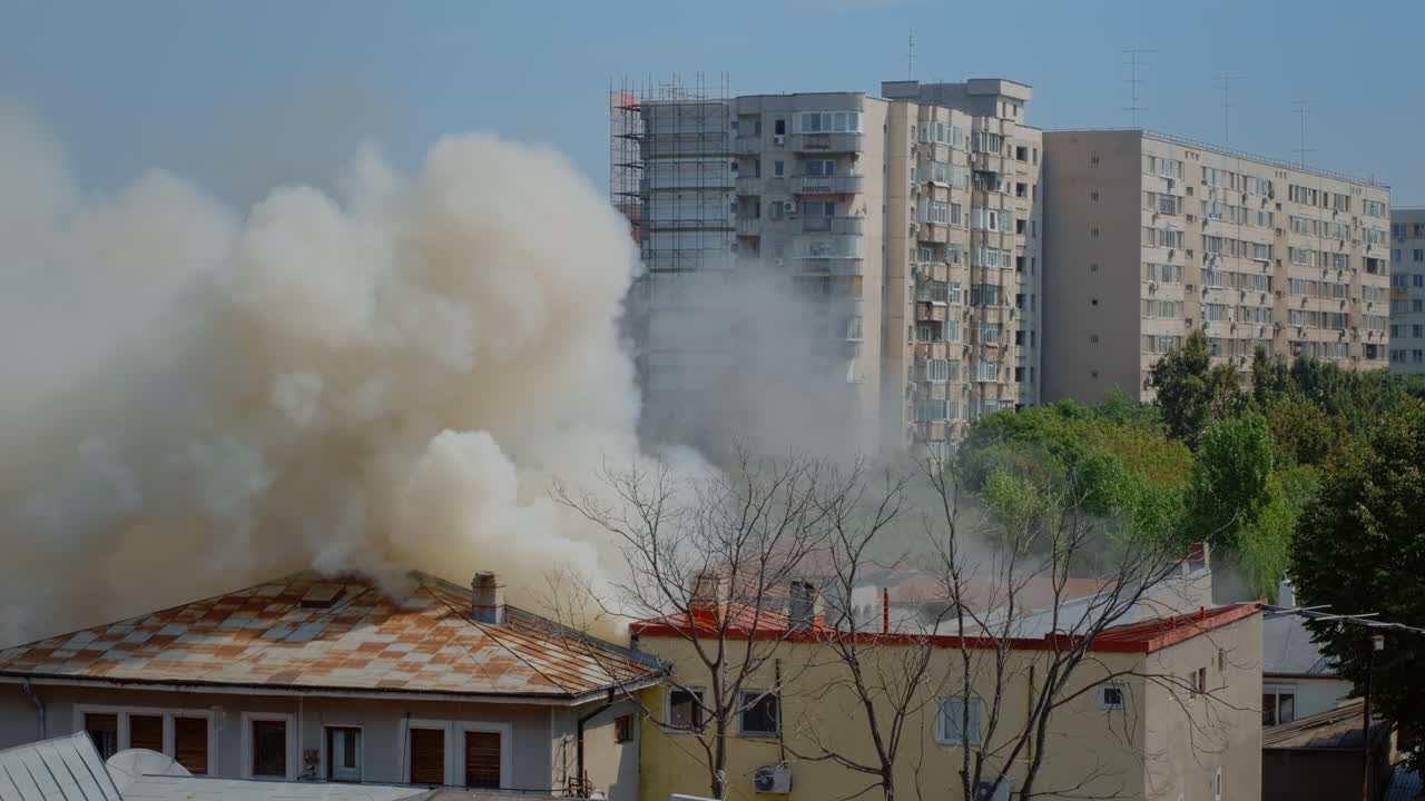 Flames going out from burning house in neighbourhood
