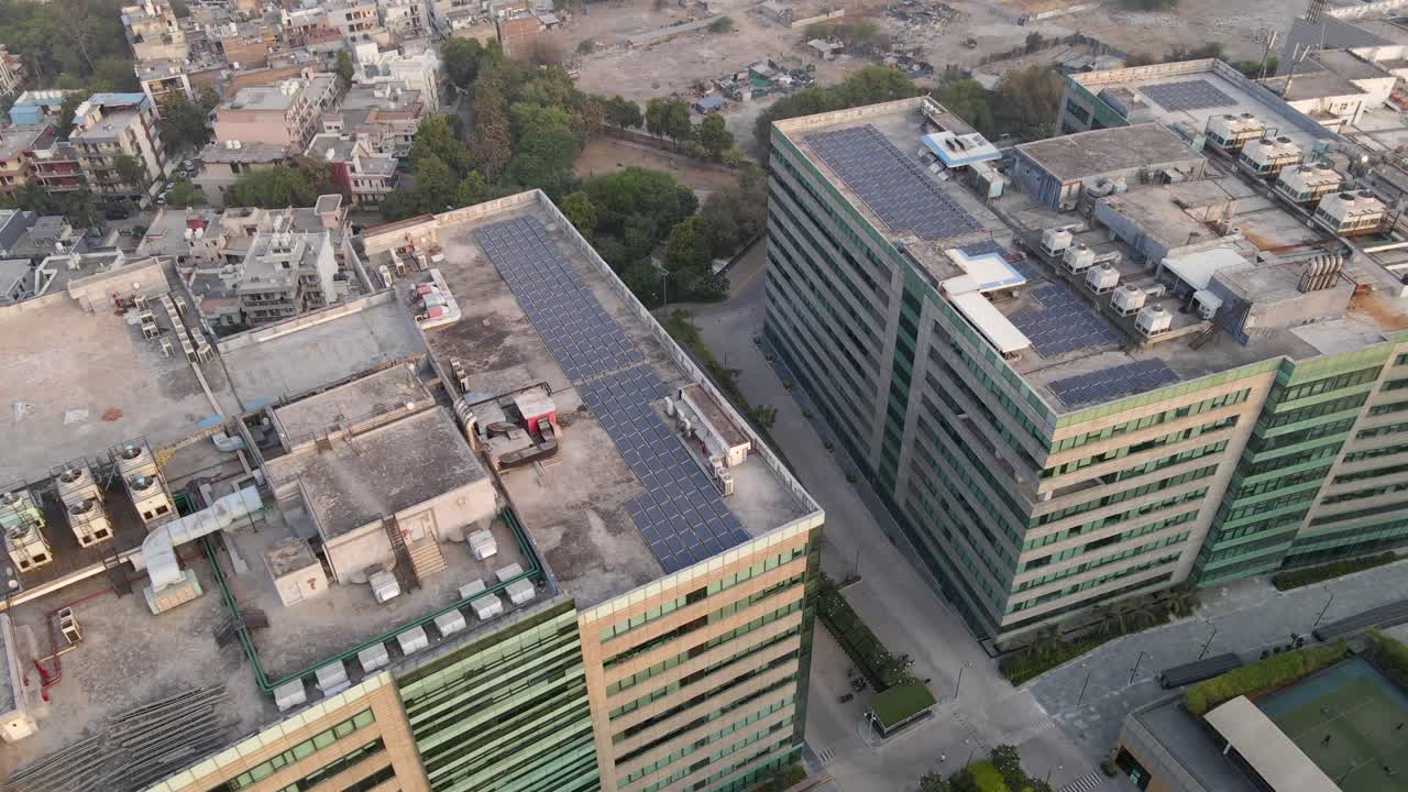 Sweeping drone shots of a sleek business park in Gurgaon, Haryana—glass skyscrapers, landscaped greenery, and urban infrastructure reflecting India’s growing global corporate presence