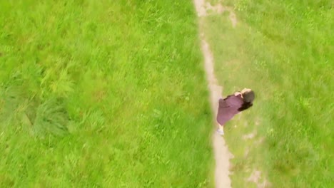 pretty girl walking in a green landscape