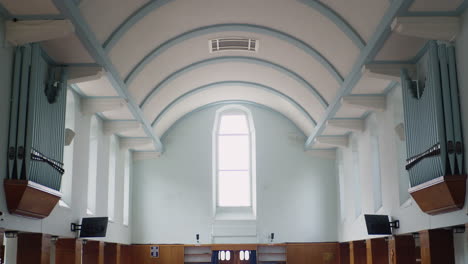 wide angle shot of organ pipes on wall of beautiful modern church