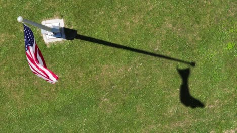 a top down view of the american flag blowing in the wind on a sunny day