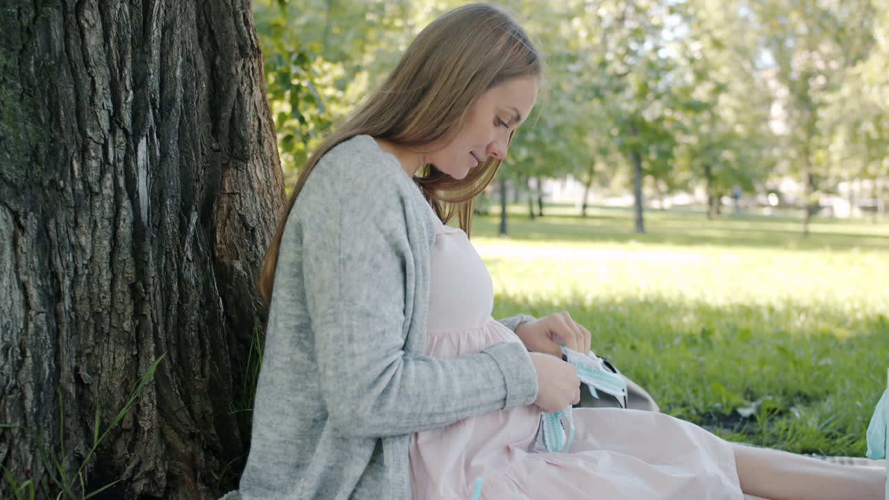 Pregnant woman preparing for baby in park