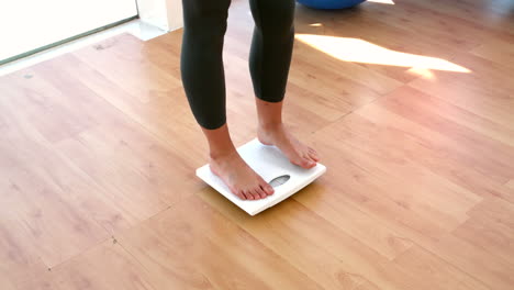 Woman-stepping-on-scales