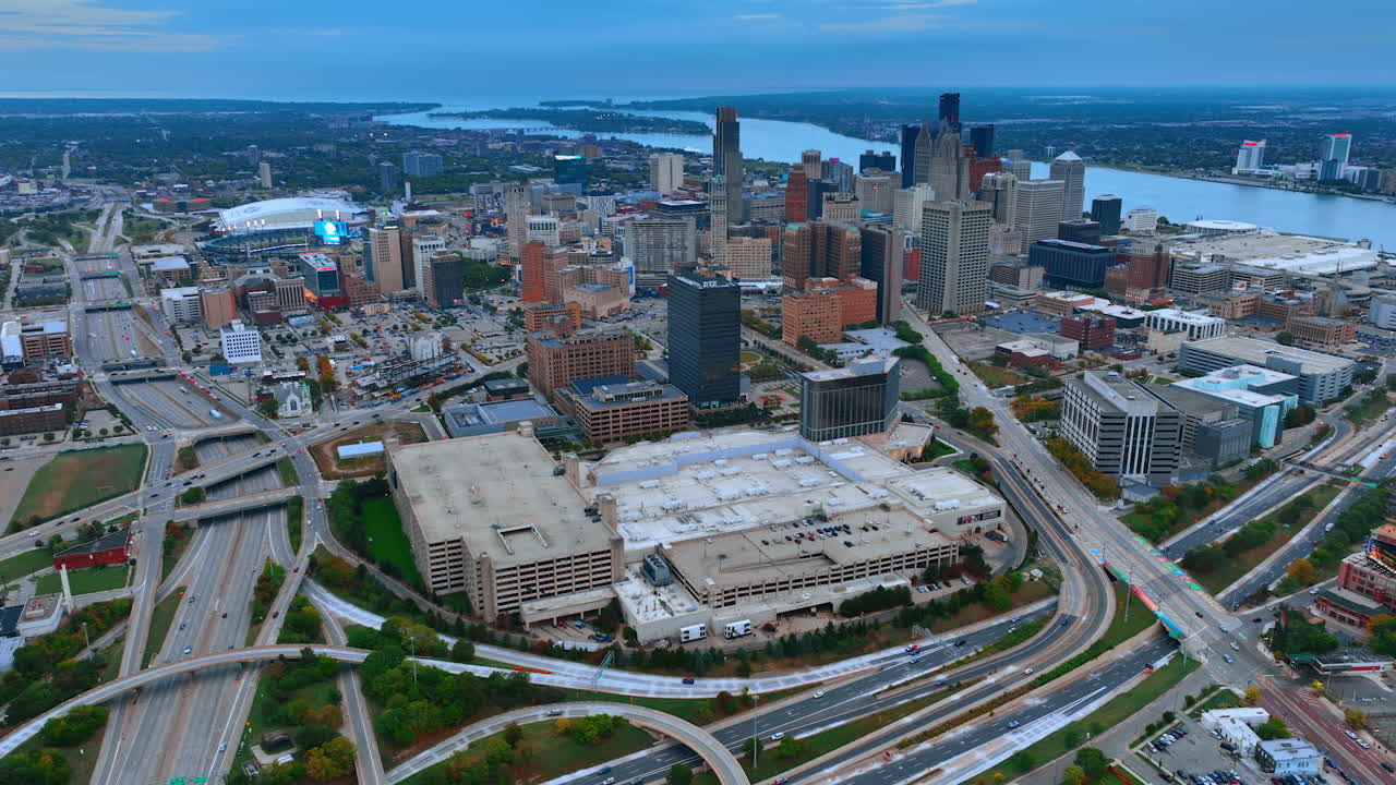 Detroit, USA, 28 July 2025: Downtown of Detroit, Michigan, USA surrounded by the system of roads. Waterscape of the Detroit River at backdrop. Aerial view