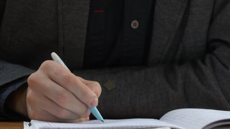 Student writing in a notebook