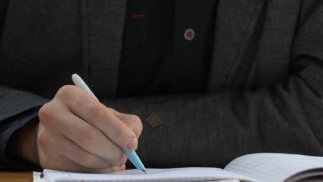student writing in a notebook