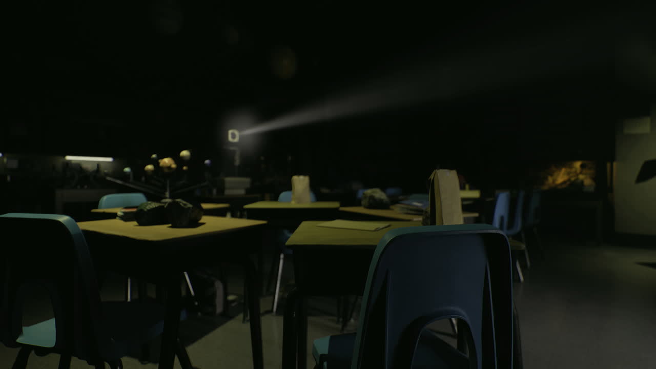 Dimly lit classroom with projection equipment during an evening event