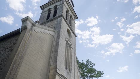 Panning-shot-upwards-church-Saint-Pierre,-Saint-Just-Chaleyssin-in-Isere-department-in-southeastern-France