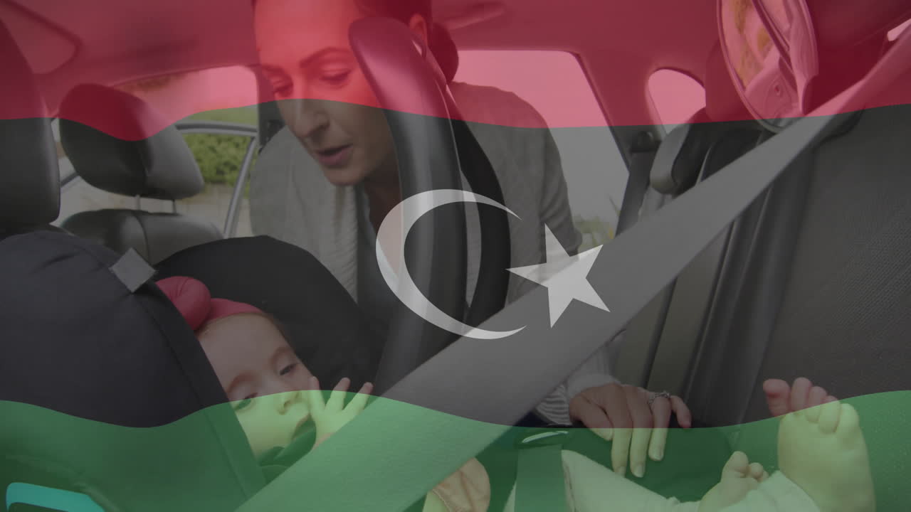 Securing baby in car seat, woman with Libyan flag animation overlay