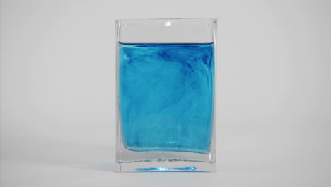 blue dye diffuses through a glass of water