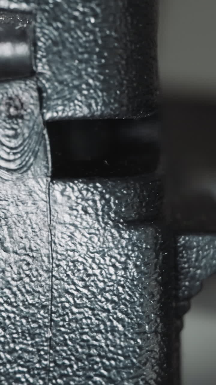 Black plug in dimly lit room with window. Movable connector attached to electrically operated device mains cable. Connecting household appliances on blurred background