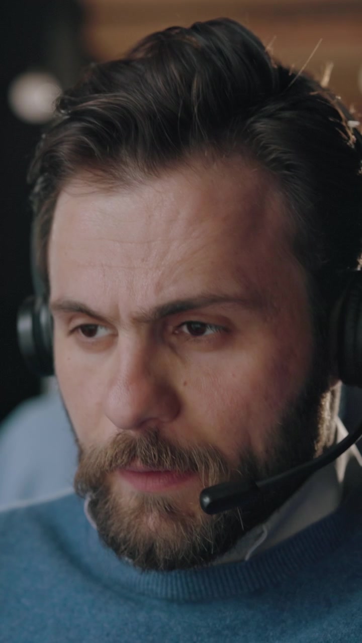 Stressed Customer Service Representative Rubbing His Forehead
