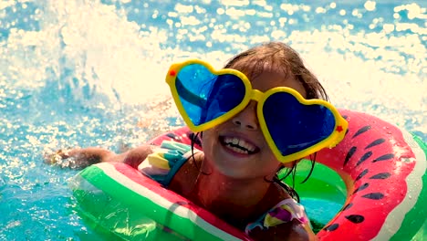 a child in a circle swims in the pool. selective focus. kid.