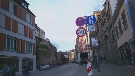 historic town of tubingen germany | tourists riding bikes on street at sunset