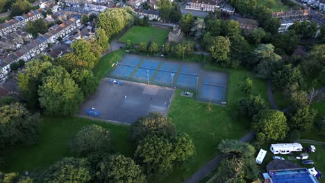 Aerial-View-of-Bruce-Castle-Park-Tennis-Courts-And-Rides-On-The-Fun-Fair-In-London,-England,-UK