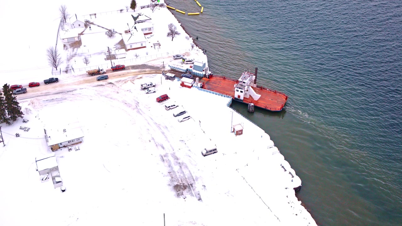 Overhead drone shot of a car ferry moving across the river near Sugar Island, Michigan.