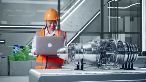 engineer examining jet engine design on laptop