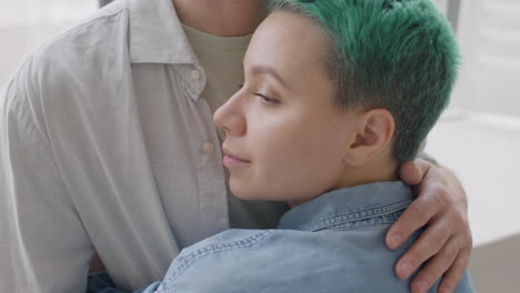 loving couple hugging and tenderly looking at each other at home