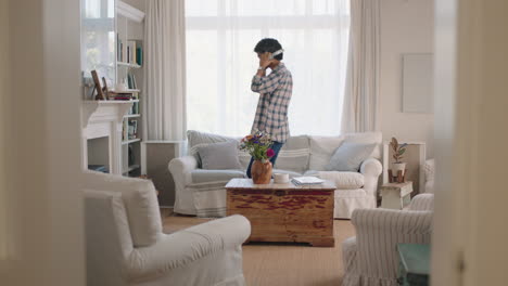 happy-young-man-dancing-at-home-celebrating-success-listening-to-music-wearing-headphones-having-fun-dance-in-living-room-on-weekend