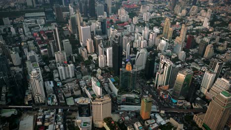 aerial scenic drone footage of the skyline of downtown bangkok, thailand covered in smog during sunset during the smokey burning season