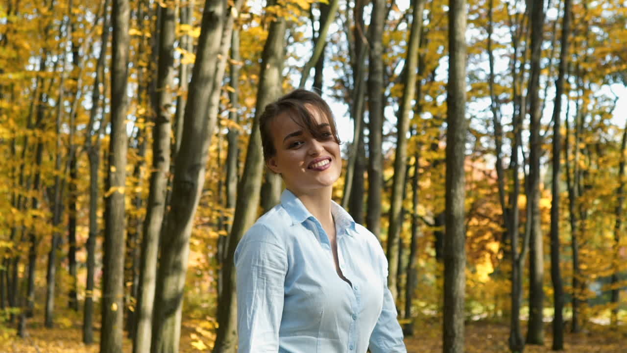 Girl walking in park. Attractive woman walking in autumn forest