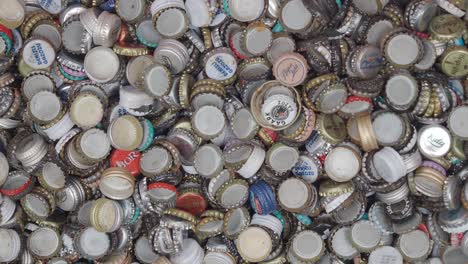 close-up of a pile of assorted bottle caps