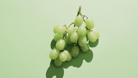 Video-of-white-grapes-with-copy-space-over-green-background