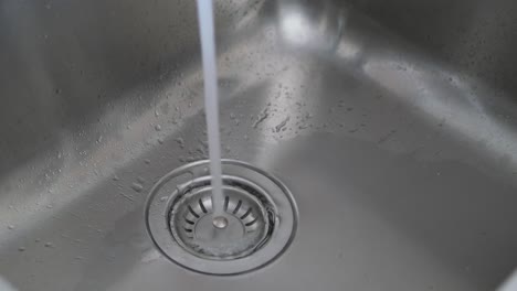 water running in stainless steel sink