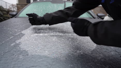 breaking ice on car after freezing rain