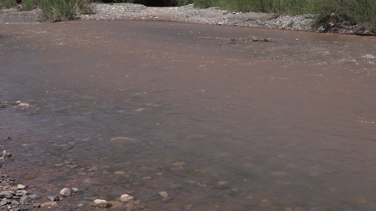 Many small rocks in the river flowing with a gentle current that is not too deep. It really makes a beautiful place for meditation