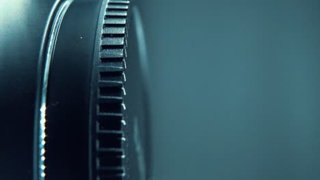 A-vertical-macro-close-up-shot-of-a-black-plastic-wheel-on-a-shiny-360-rotating-stand,-cinematic-studio-lighting,-120-fps,-Slow-motion,-Full-HD-video