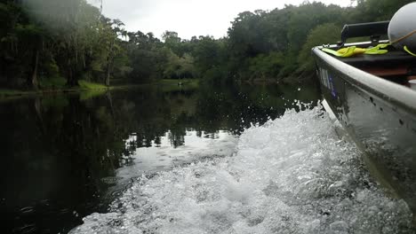 driving a boat down a river in slow motion