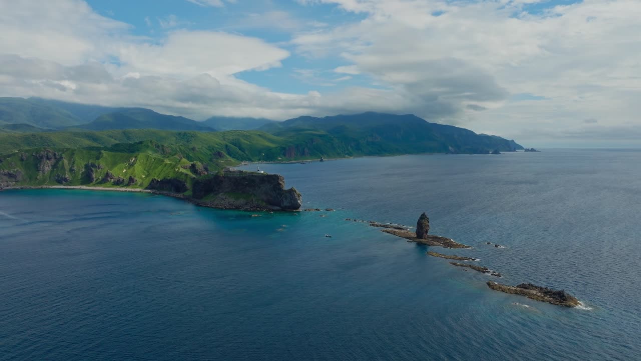 Establishing Aerial view of Shakotan Japanese green cliff, sea landscape with famous stone caves