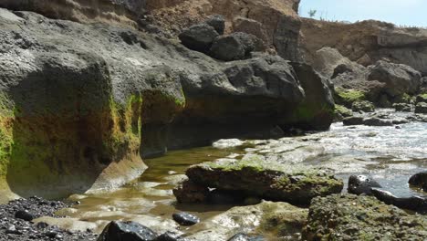 Looking-at-rock-formations-during-low-tide,-panning-POV