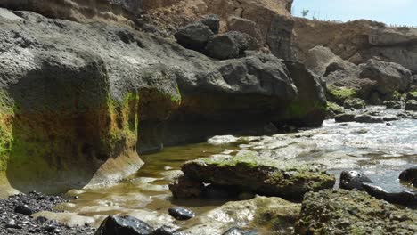 looking at rock formations during low tide, panning pov