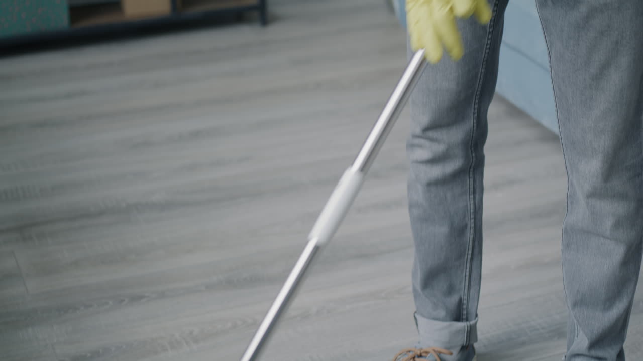 Man Cleaning a Floor with a Vacuum