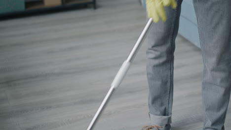 man cleaning a floor with a vacuum