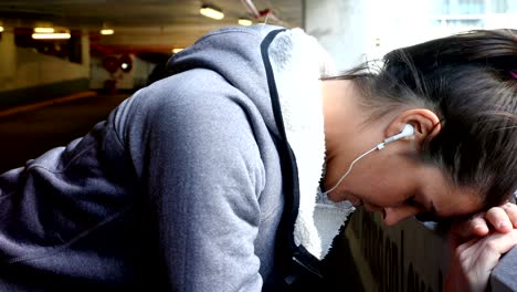 woman taking break at underground car parking lot 4k