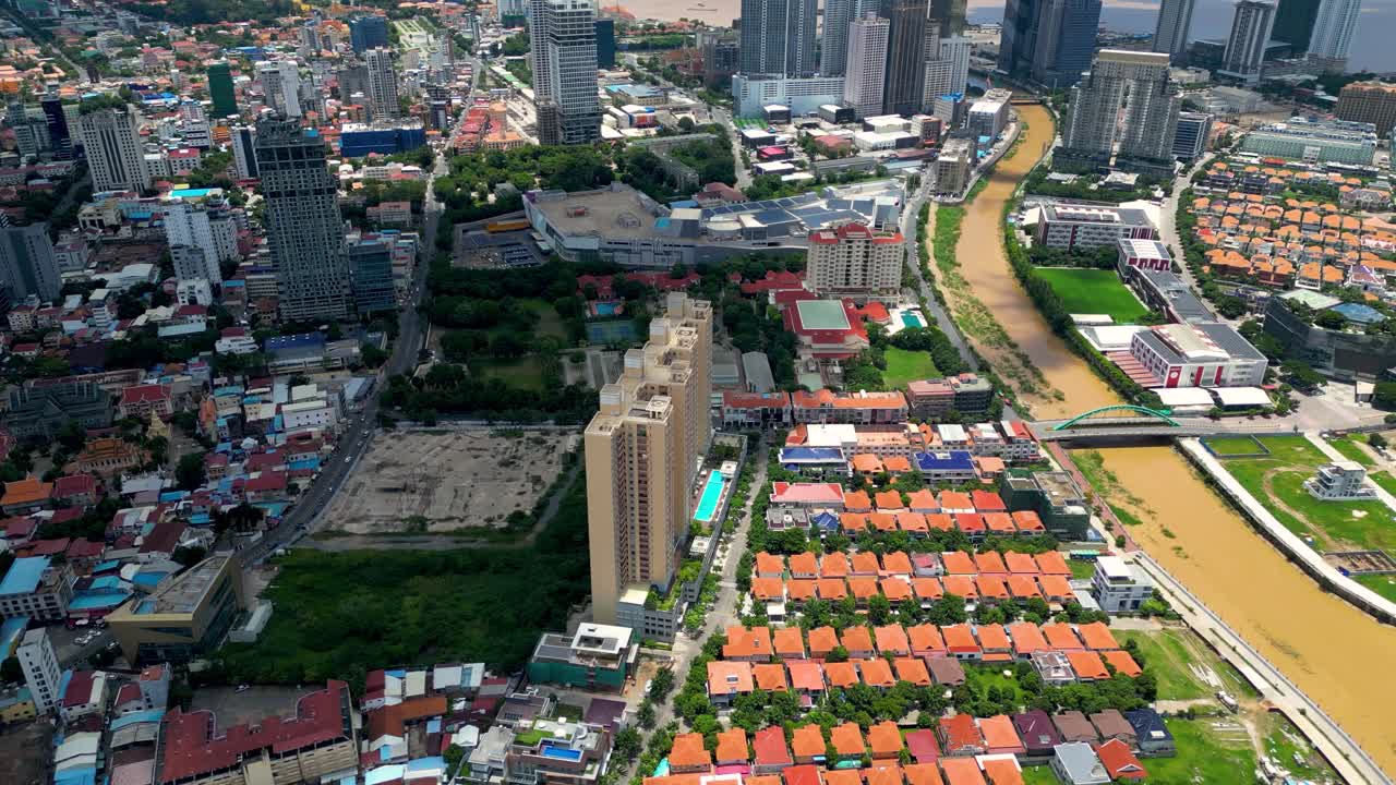Phnom penh cityscape featuring the bassac river and koh pich district in bright daylight, aerial view