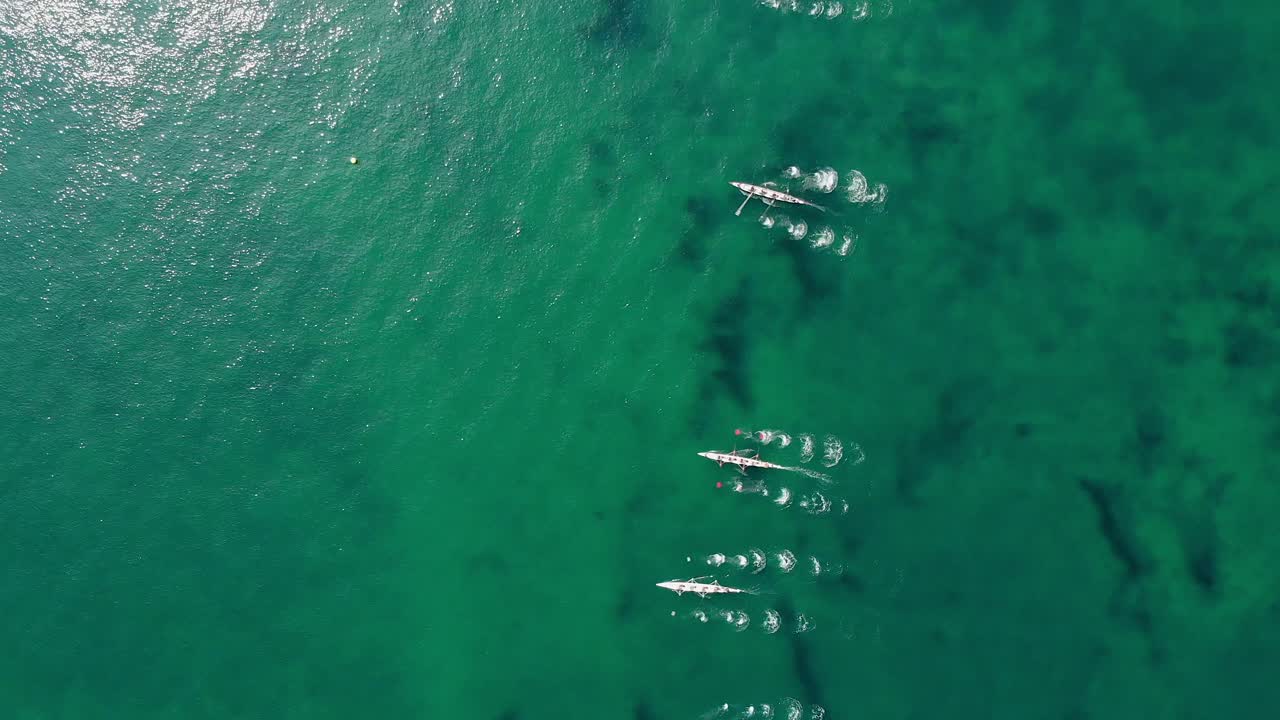 4K aerial view of rowing boats in the sea start of a rowing race.