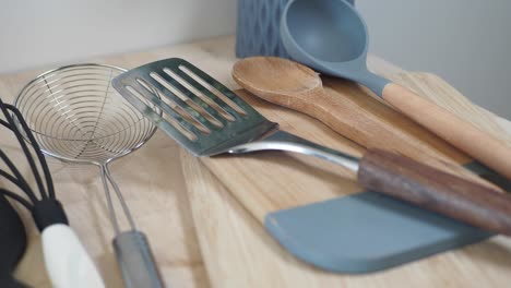 kitchen utensils on a wooden cutting board