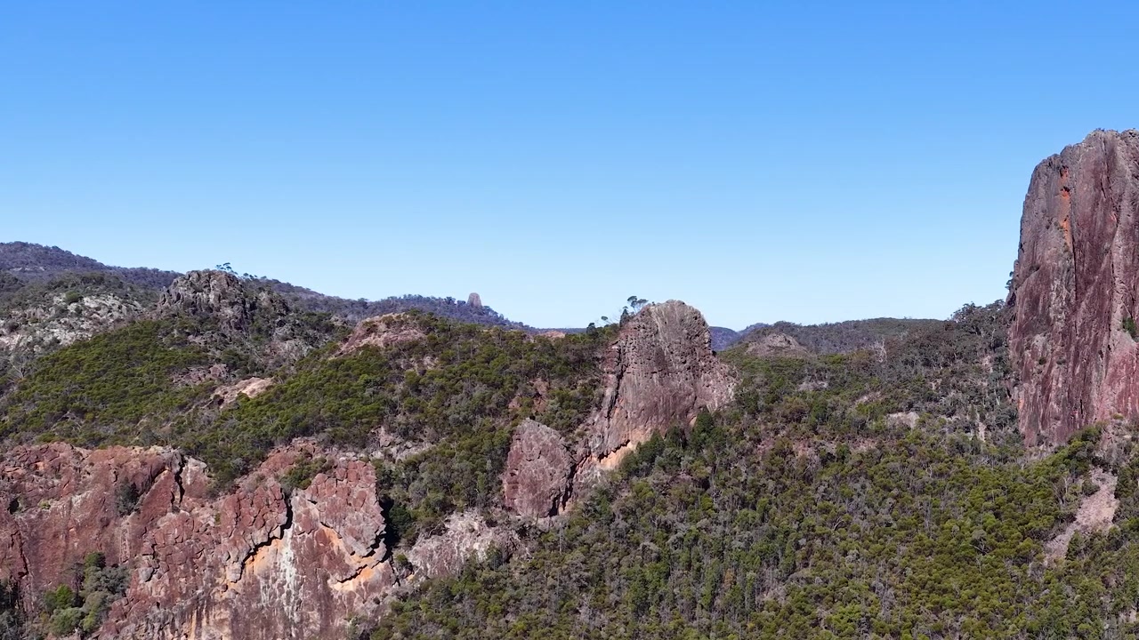 Ampia ripresa aerea di formazioni rocciose vulcaniche e natura selvaggia nel Parco Nazionale di Warrumbungle, Australia